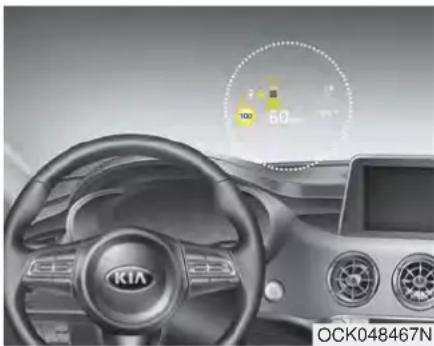 Interior view of a car dashboard with KIA brand logo and speedometer display (no readable text or symbols)