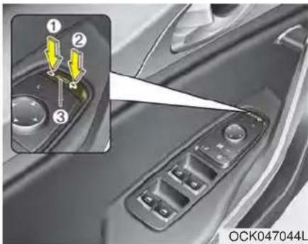 Close-up of a car's side panel with three labeled buttons and a highlighted lever (no text or symbols visible)