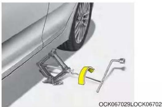 Technical illustration of a car wheel and its mounting bracket assembly (no text or symbols)