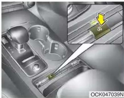 Mechanical assembly showing a gear shift and tool interacting with a component (no visible text or symbols)