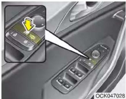 Close-up of a car's side panel with a highlighted control panel and warning icon (no text or symbols on the main subject)