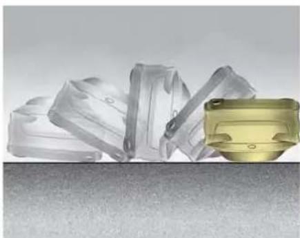 Two plastic mechanical components, one with a yellow base and the other with translucent plastic parts (no text or symbols visible)
