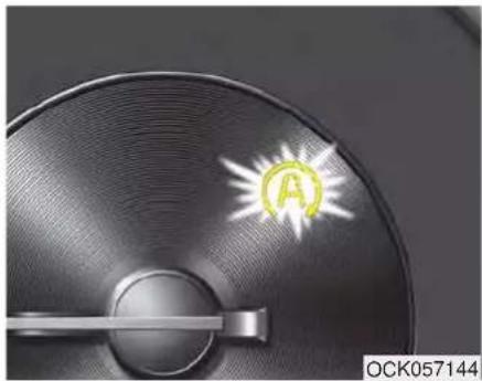 Close-up of a metallic circular object with a glowing circular symbol and label 'OCK057144' (no readable text or symbols on the object itself)