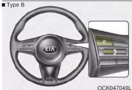 Interior view of a car steering wheel with KIA brand logo and external control panel (no readable text or symbols)