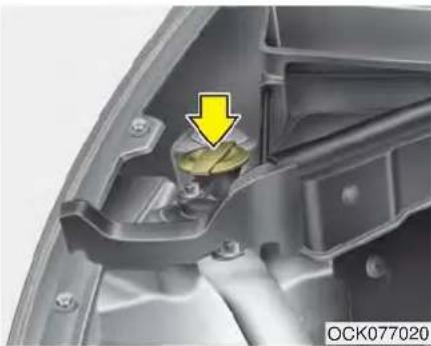 Close-up of a car's internal component with a yellow arrow pointing to a yellow component (no text or symbols visible)