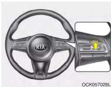 Interior view of a car steering wheel with KIA brand logo and a highlighted control panel (no text or symbols on the diagram itself)