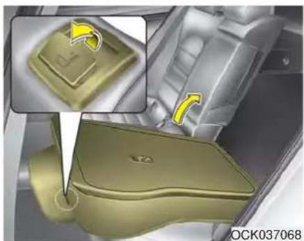 Interior view of a car seatbelt with a highlighted component and directional arrows (no text or symbols)