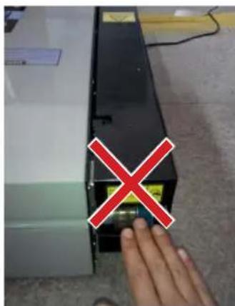 Photo showing a hand pressing a device with a red X mark, indicating a warning or rejection symbol.
