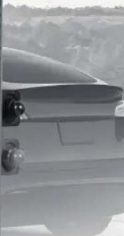 Side profile of a car with visible dashboard and side-mounted sensors (no text or symbols)