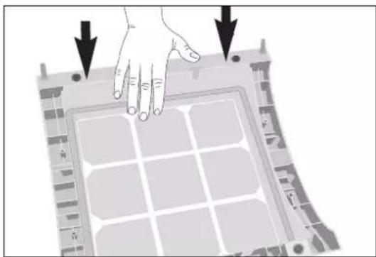 Diagram of a hand pressing down on a grid-like panel with arrows indicating force or movement (no text or symbols)