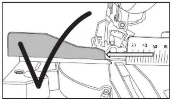 Technical diagram showing a mechanical measuring tool with a checkmark and scale markings, likely for assembly or inspection.