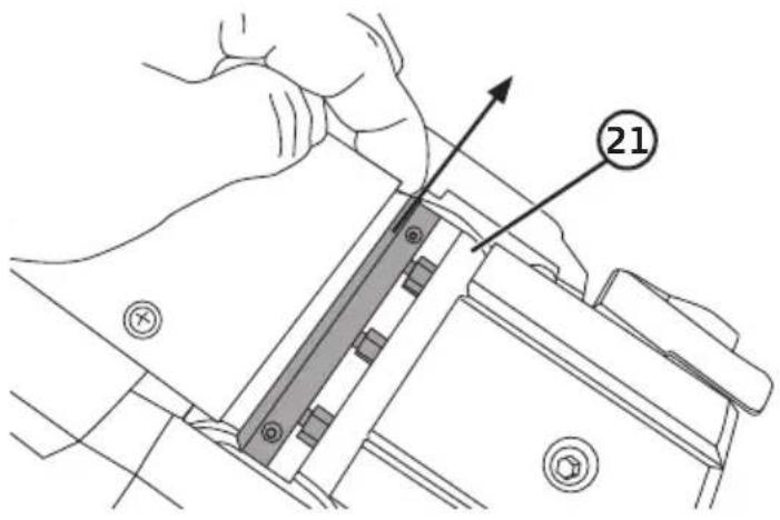 Technical diagram showing a hand operating a mechanical component with labeled part 21 and directional arrow