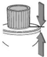 Diagram showing a cylindrical object with a curved arrow indicating direction, no text or symbols present