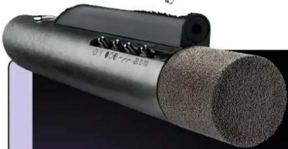 Close-up of a cylindrical mechanical component with textured surface and visible internal structure (no text or symbols)