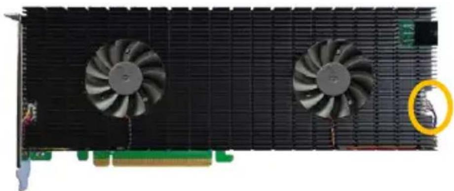 Front view of a black GPU card with two cooling fans and a yellow circular inset showing a mechanical component (no text or symbols visible)