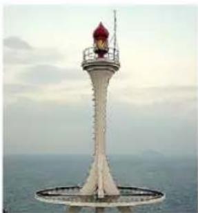 Lighthouse with red canopy against a cloudy sky and sea background (no text or symbols visible)