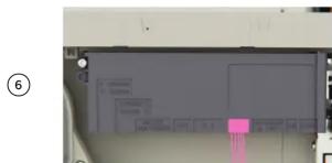 Cropped image showing a device with labeled components and a pink arrow pointing to a specific area, possibly indicating a location or annotation.