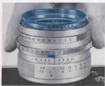Close-up of a precision camera lens with measurement markings and control panel visible