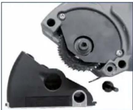 Close-up of mechanical components including a gear and a black plastic housing (no visible text or symbols)