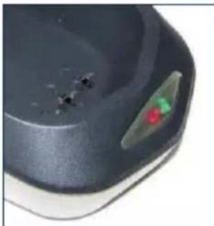 Close-up of a dark, glossy surface with a small green and red mark on the right side (no text or symbols visible)