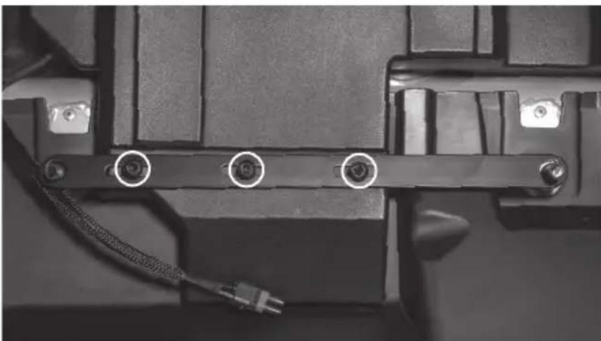 Close-up of a mechanical component with three circular annotations pointing to pins, no visible text or symbols.