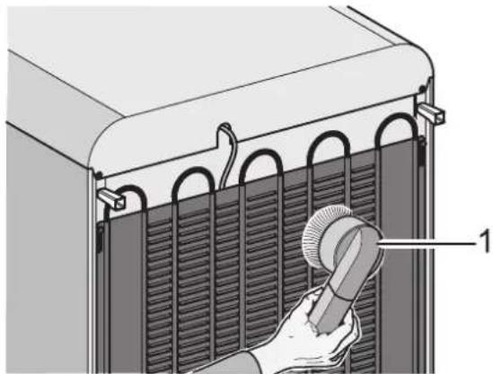 Diagram of a hand holding a tool inside a heat exchanger panel with cooling fins (no text or symbols)