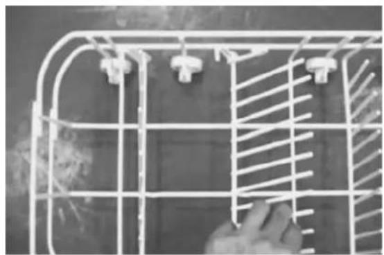 Close-up of a white wire cage with metal grilles and connectors, no visible text or symbols