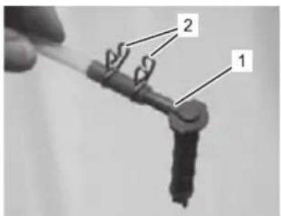 Labeled diagram of a mechanical component with parts numbered 1 and 2, showing a spring-like structure.