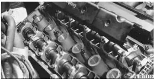 BMW 325i (2002) - Remove oil baffle cover from above intake camshaft. - 1