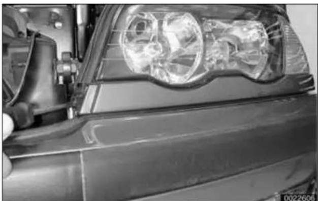 BMW 325i (2002) - Headlight housing trim panel, removing and installing - 1