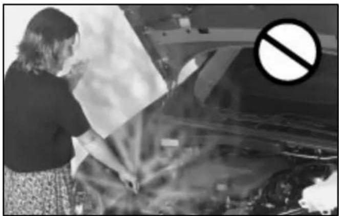 Black-and-white photo of a woman inspecting the hood of a car with a large 'no' symbol overlay (no readable text or symbols)