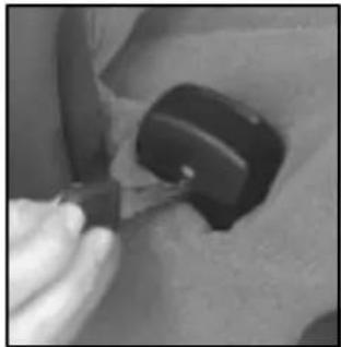 Close-up of a hand using a tool to adjust or install a black mechanical component (no visible text or symbols)