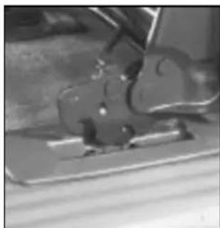 Close-up of a mechanical component or tool on a surface, no visible text or symbols