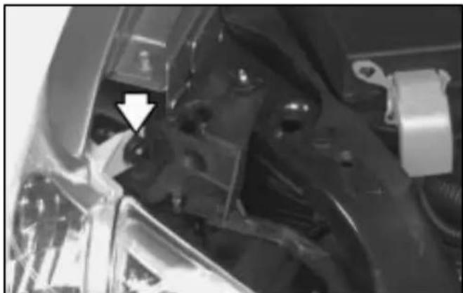 Close-up of mechanical components with a white arrow pointing to a specific part (no visible text or symbols)