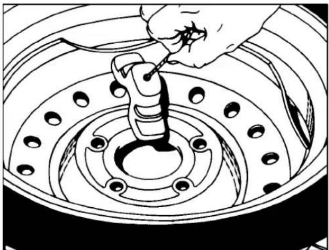 Line drawing of a hand using a tool to adjust or install a car wheel rim (no text or symbols present)