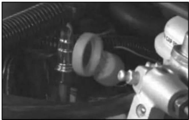 Close-up of mechanical components including hoses and a valve (no visible text or symbols)