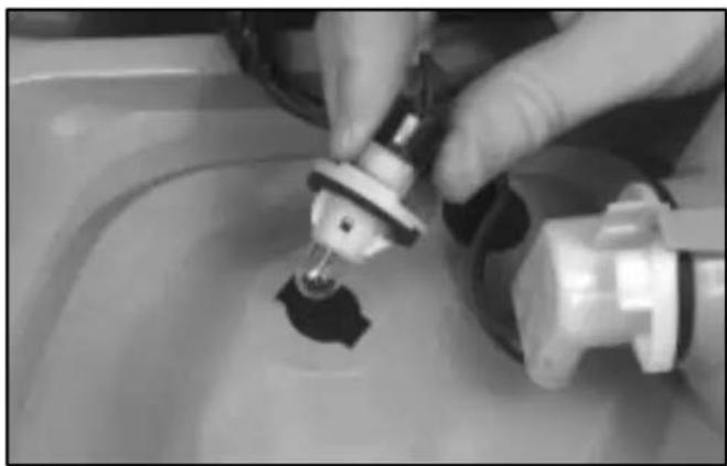 Close-up of hands using a tool to apply liquid into a container (no visible text or symbols)
