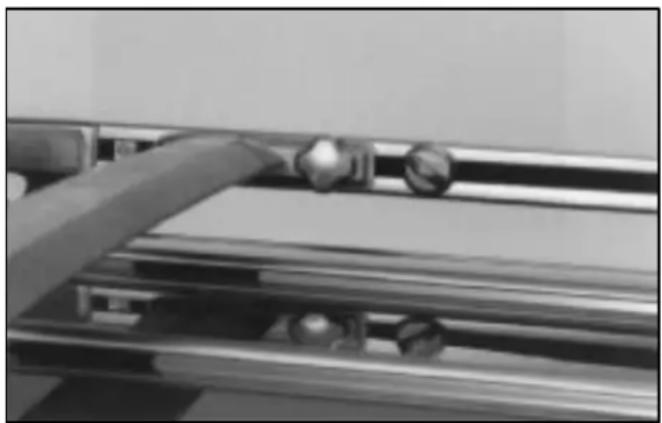 Close-up of a mechanical component with metallic parts and a curved pipe (no visible text or symbols)