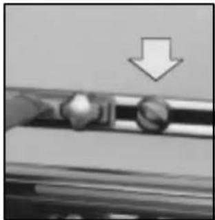 Close-up of a mechanical component with a downward arrow indicator (no text or symbols)