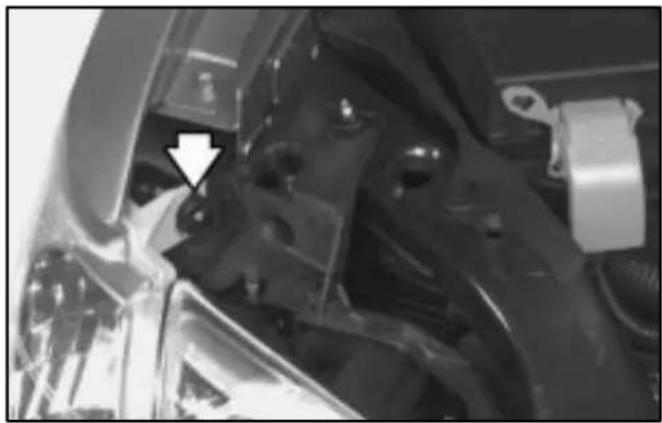 Close-up of mechanical components with a white arrow pointing to a specific part (no visible text or symbols)