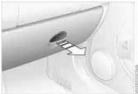 Close-up of a metallic device with a circular hole and a directional arrow pointing to it (no visible text or symbols)