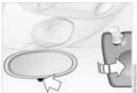 Illustration of a hand holding a circular object with an arrow pointing to it, next to a smartphone (no text or symbols visible)