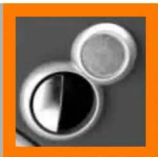 Close-up of two circular objects with reflective surfaces, one black and one white, against a gray background (no text or symbols)