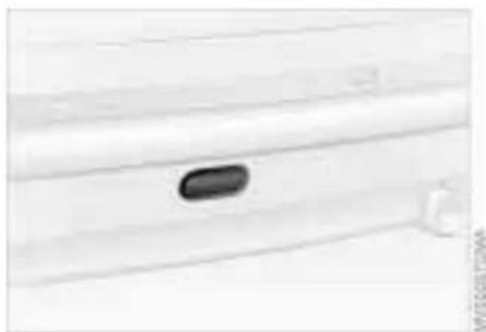Close-up of a white electronic device with a small black button on the side panel (no visible text or symbols)