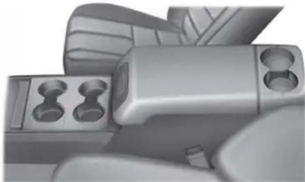 Close-up of a metallic mechanical component with four circular cutouts and a cylindrical housing (no visible text or symbols)
