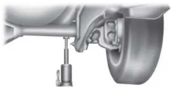 Mechanical assembly diagram showing a car suspension system with a vertical guide and wheel (no text or symbols)