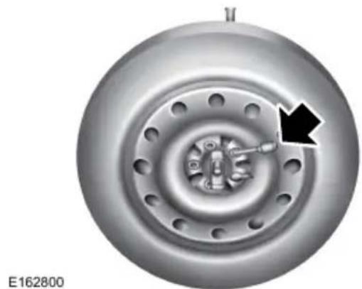 Close-up of a car brake disc with a black arrow pointing to the inner gear (no text or symbols on the disc itself)