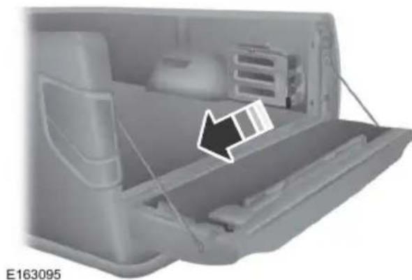 Interior view of a vehicle rear compartment showing the door, seat, and chassis (no text or symbols visible)