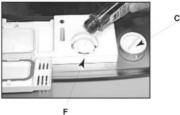Diagram of a device with labeled components and directional arrows, including a tool and dial indicator.