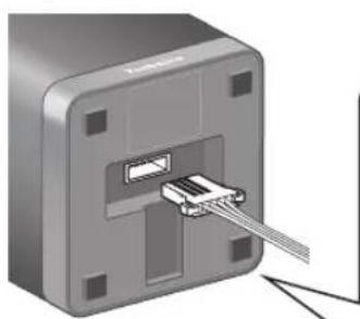 Close-up of a mechanical component with a metallic connector inserted, showing internal structure and mounting holes (no text or symbols visible)
